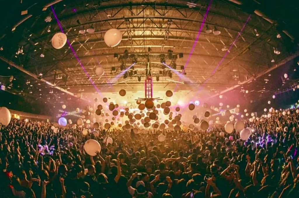 Balloons fall above a crowd as New Year's strikes at Decadence Colorado