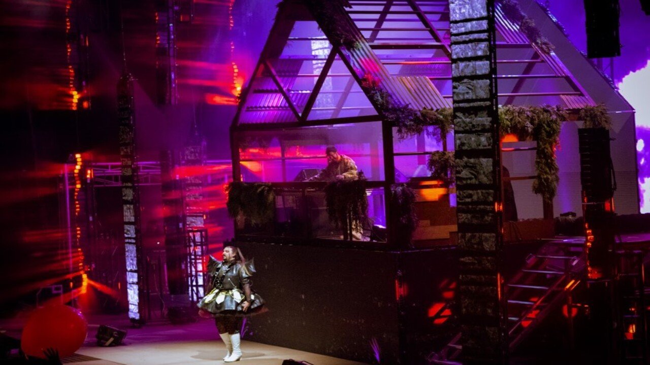 EDM artists perform on a brightly lit stage