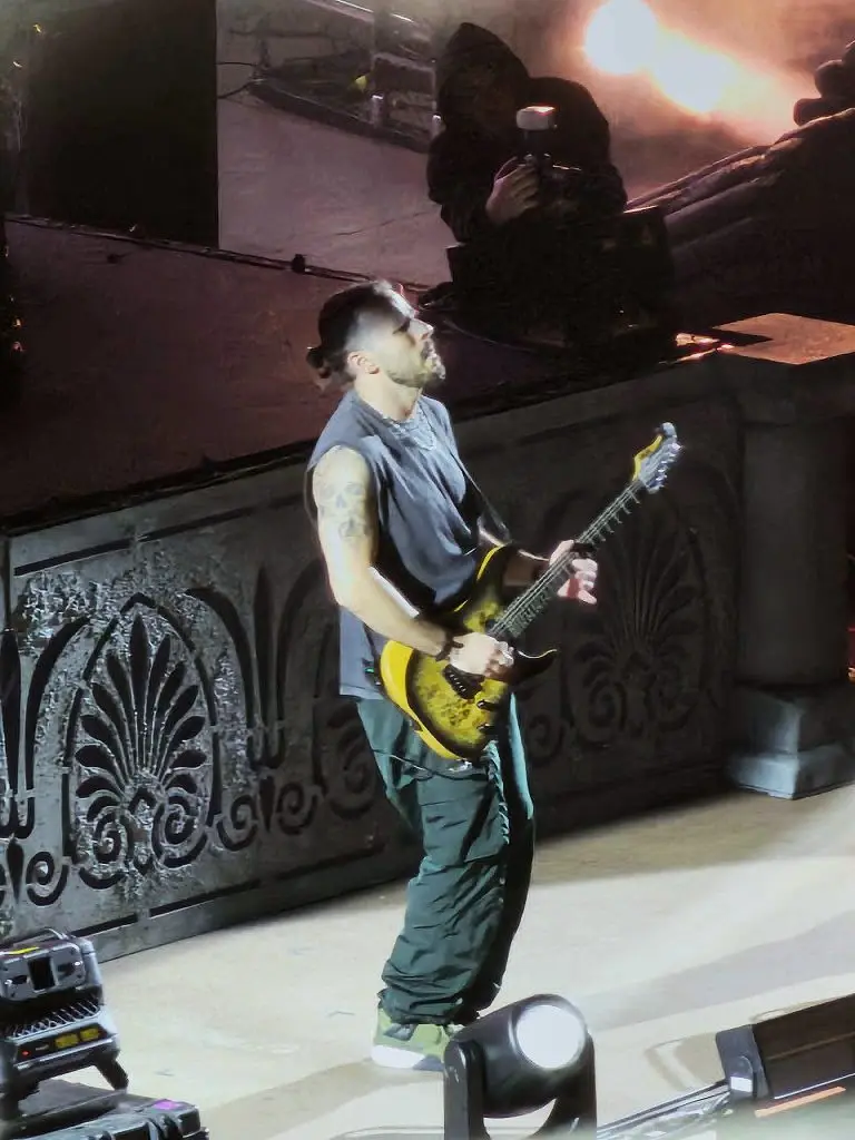 A guitarist is shown playing onstage