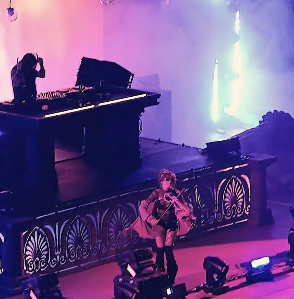 A violinist and an EDM DJ perform onstage
